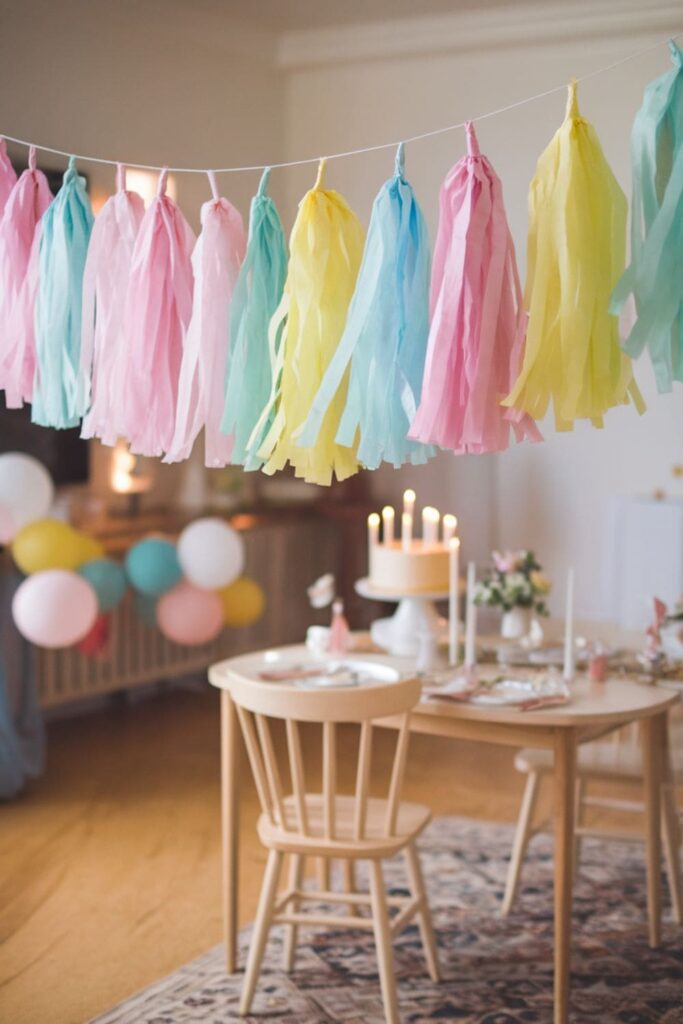 DIY paper tassels in pastel shades, hanging as part of a festive garland, with a celebration in the background