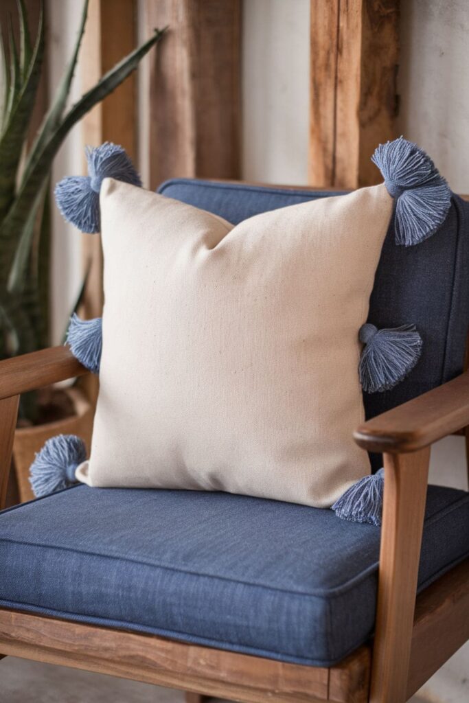 Denim pillow decorated with tassels made from thin denim strips, adding a playful and boho touch to the pillow's edges