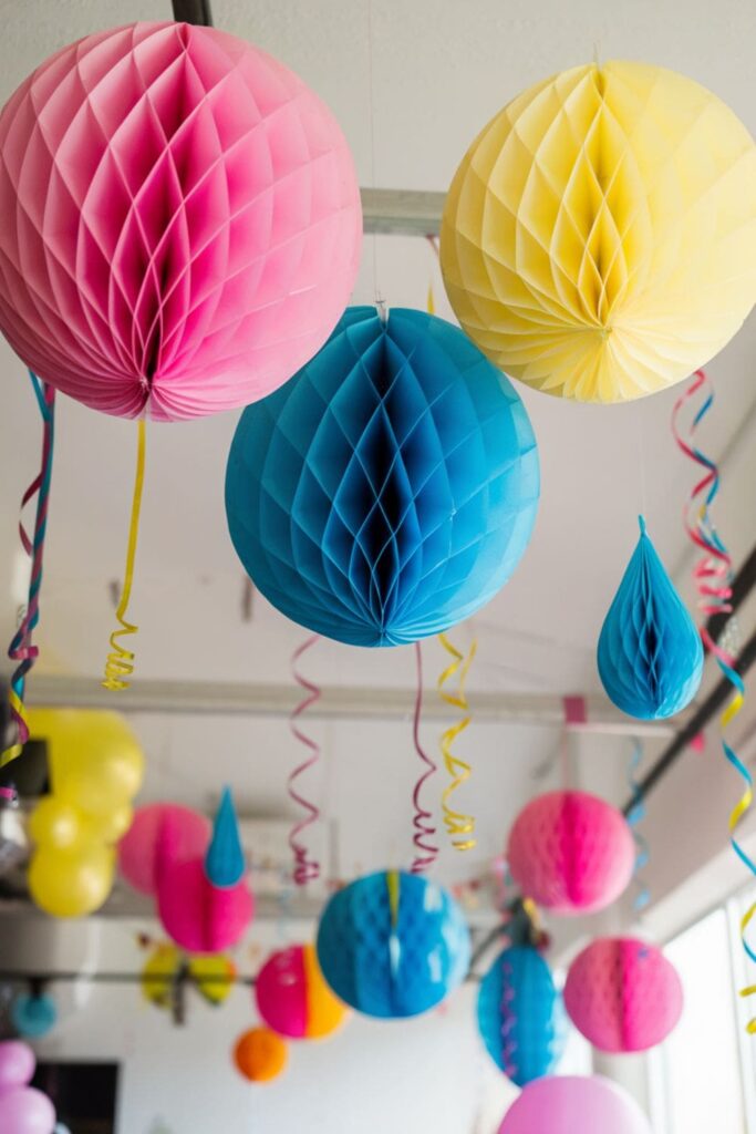 Bright honeycomb paper decorations hanging at a party