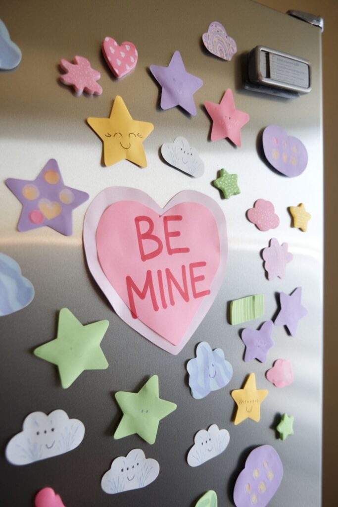 Fun-shaped DIY magnets made from thick paper, decorated with markers and stickers, displayed on a refrigerator door