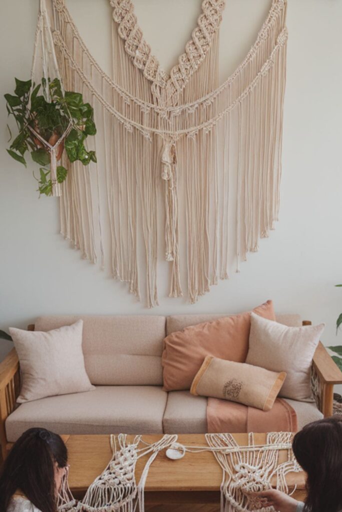 Hands creating macramé wall hangings with soft cotton cords