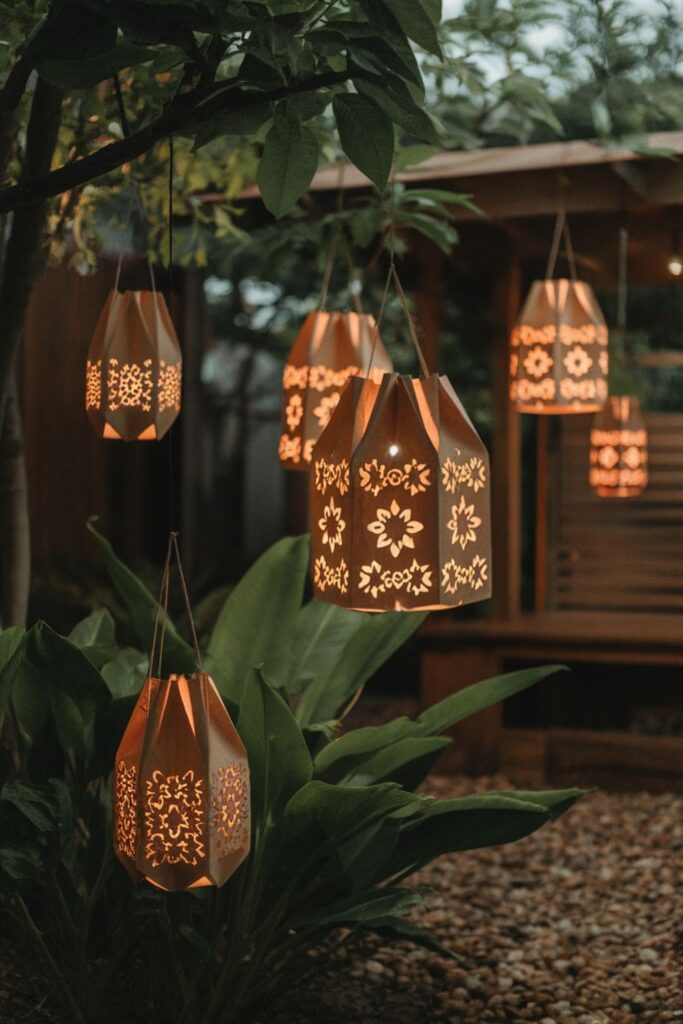 Hanging paper bag lanterns with intricate designs glowing in a garden at dusk