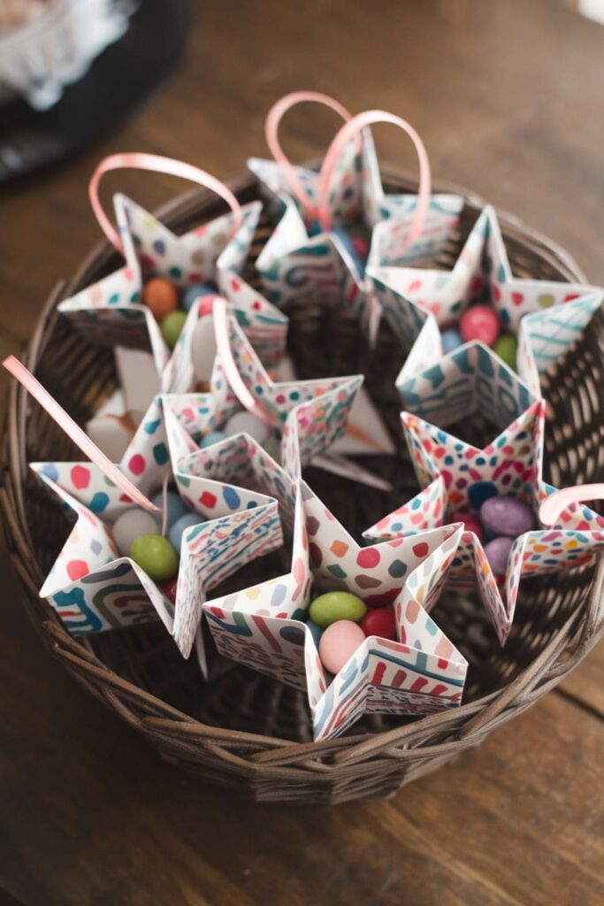 Patterned paper stars filled with candies and ribbon loops