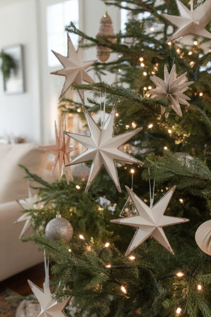 Shimmery paper star ornaments on a decorated Christmas tree