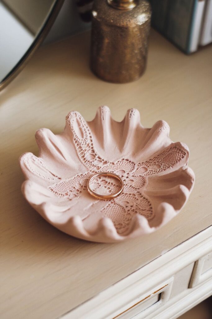 Simple clay ring dish with lace patterns on a vanity