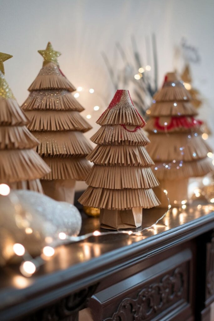 Small layered paper bag Christmas trees with glitter on a holiday mantelpiece