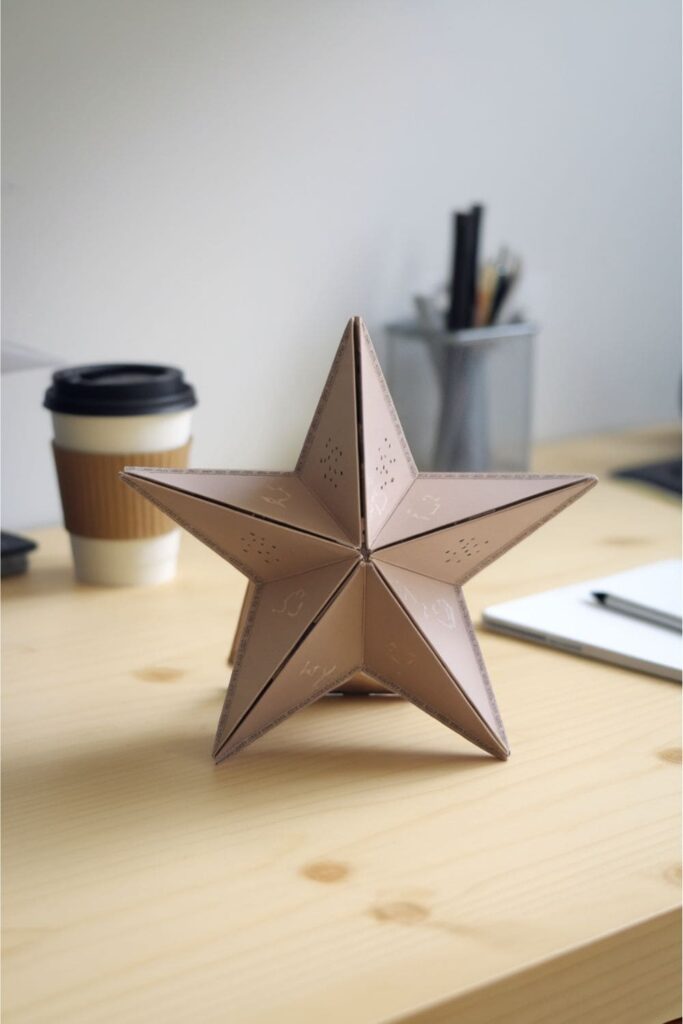 Star-shaped paper tablet stand on a desk with stationery