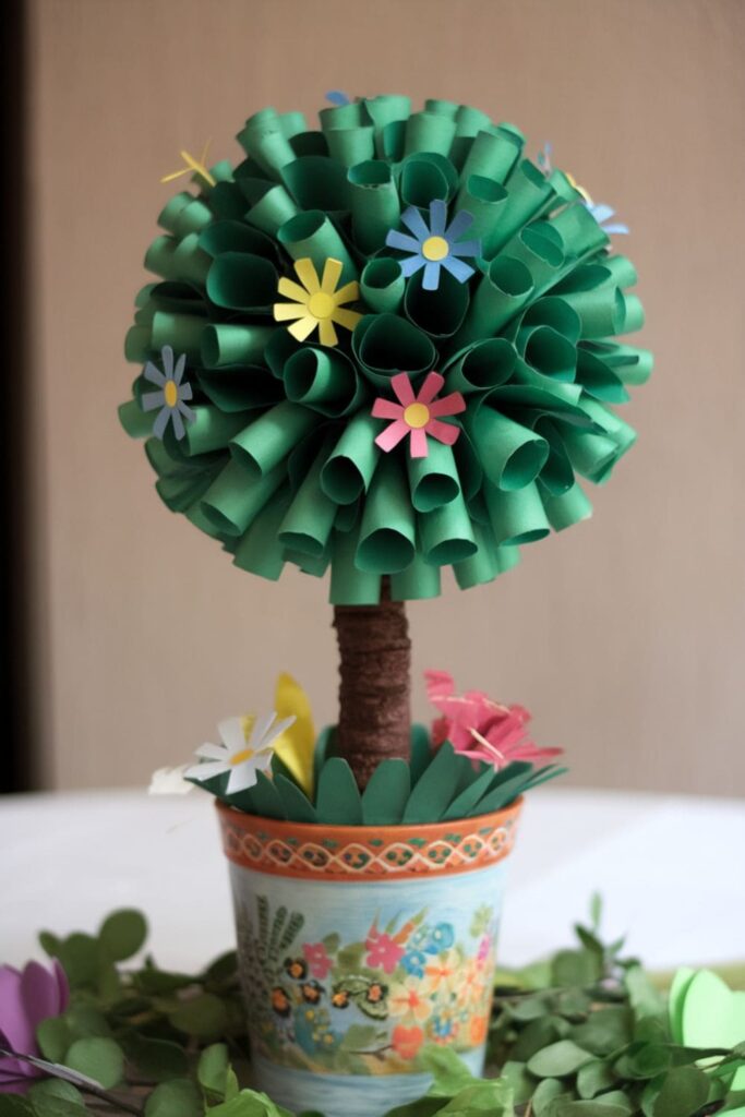 Whimsical paper topiary tree with green cones and a decorative pot