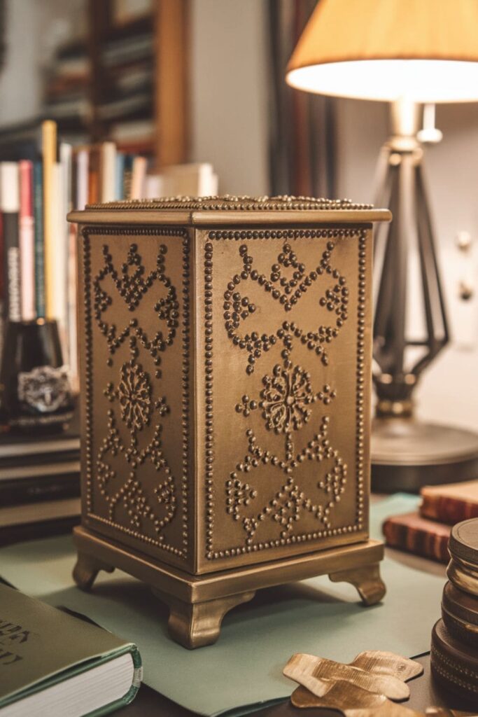 Antique gold embossed box on a table in a cozy study