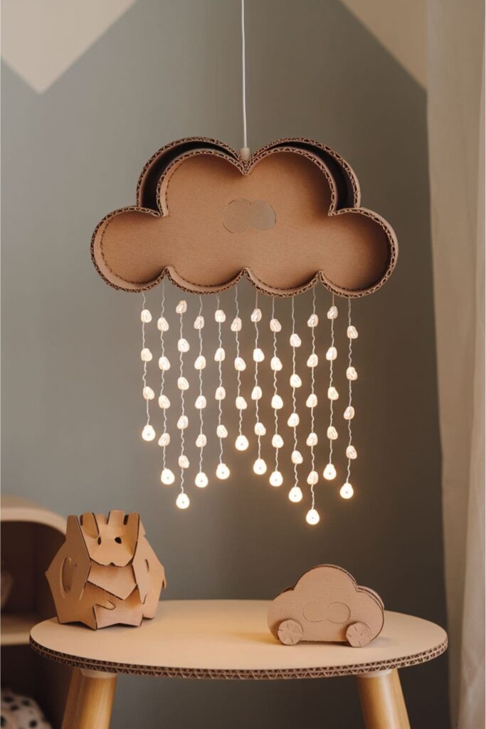 Cardboard rain cloud with LED raindrops hanging from it on a table