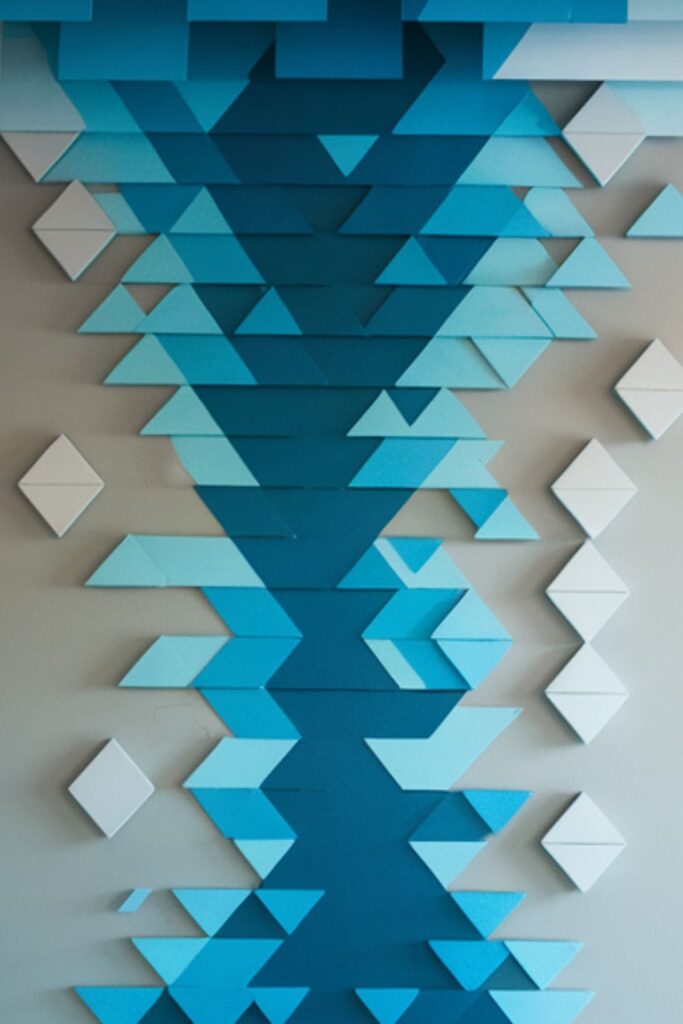 Geometric cardboard shapes layered to mimic a cascading waterfall