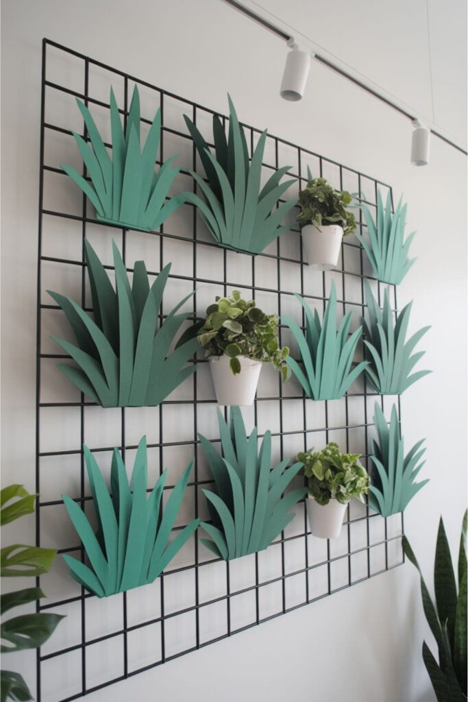 Grid wall with cardboard plants and live greenery in alternating sections