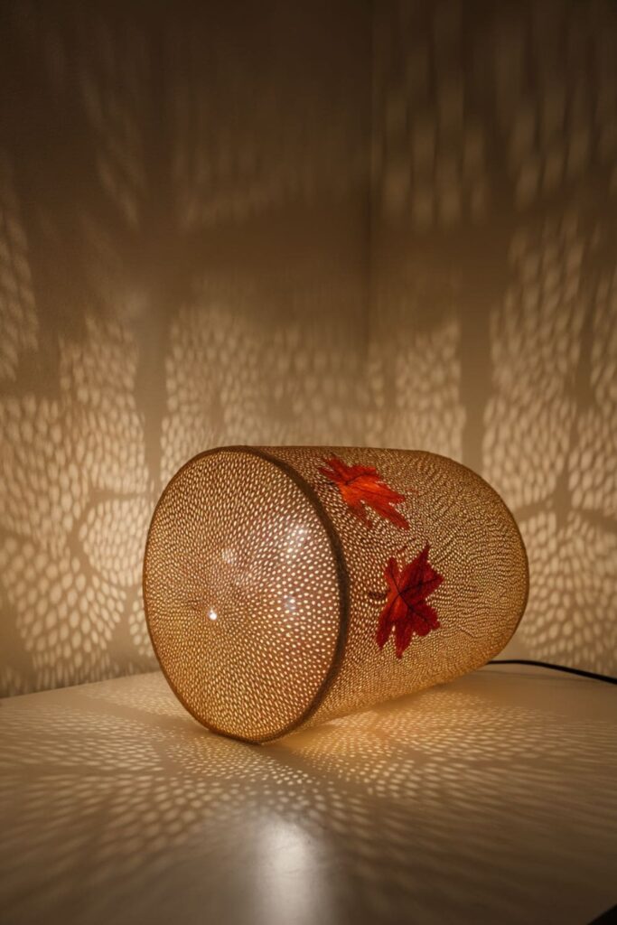 Hot glue lampshade overlay with leaf patterns on a table