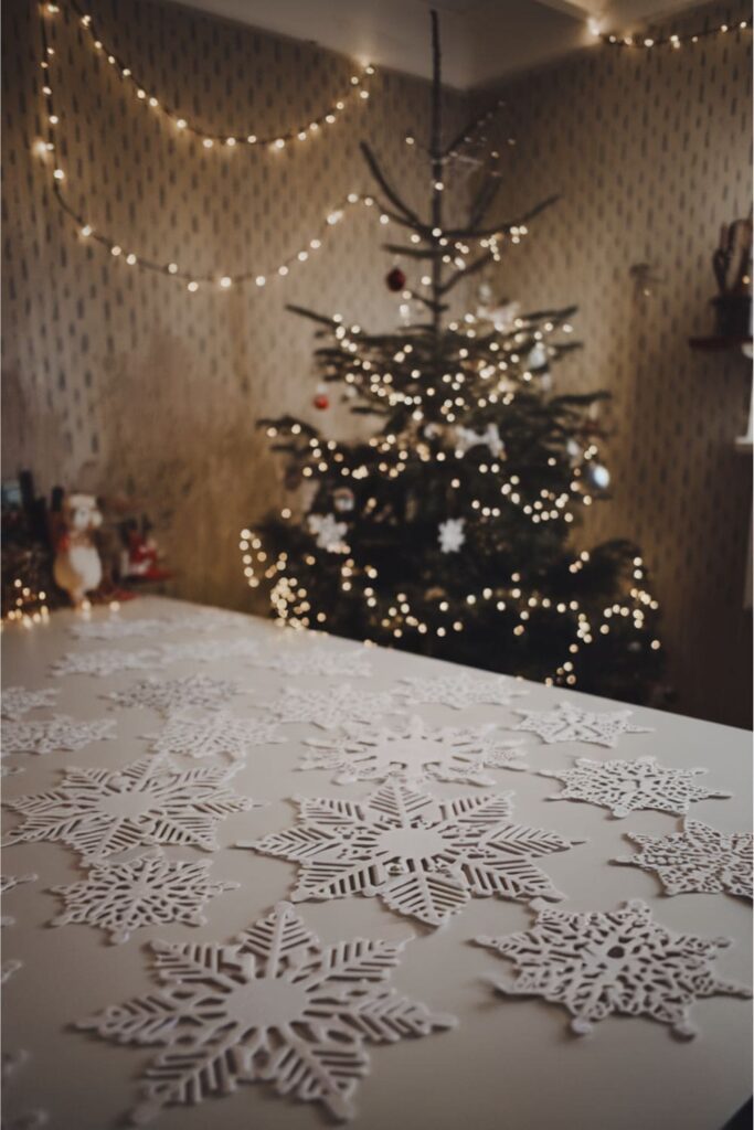 Intricate paper snowflakes from A4 sheets on a white table