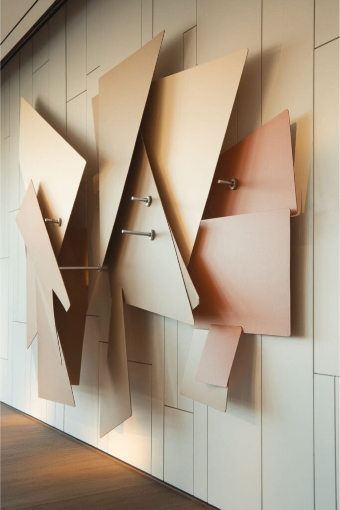 Moving cardboard wall art with pivoting shapes that rotate gently