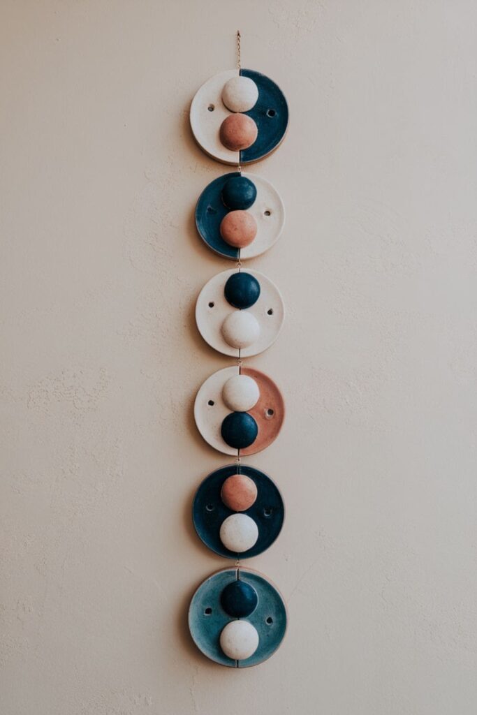 Multi-layered clay wall hanging showing lunar eclipse phases