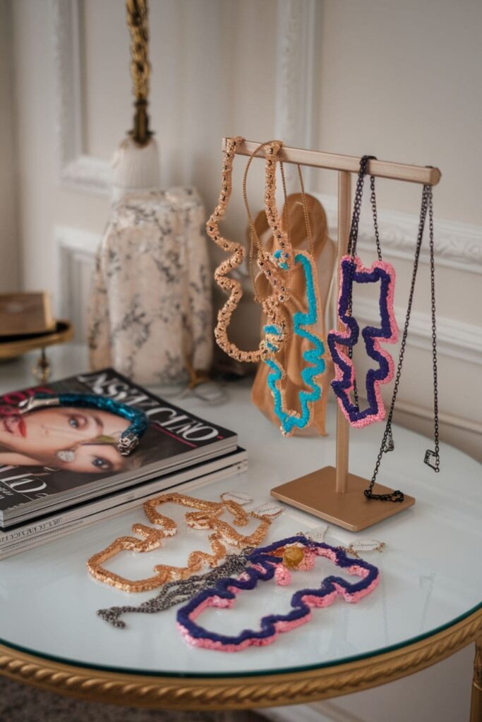 Painted hot glue necklaces with bold designs on display