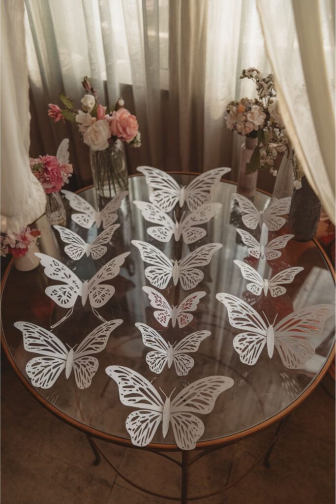 Paper butterflies crafted from A4 sheets on a glass table