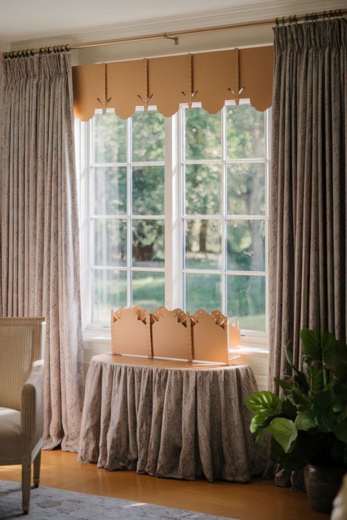 Scalloped cardboard window valance painted white on a table