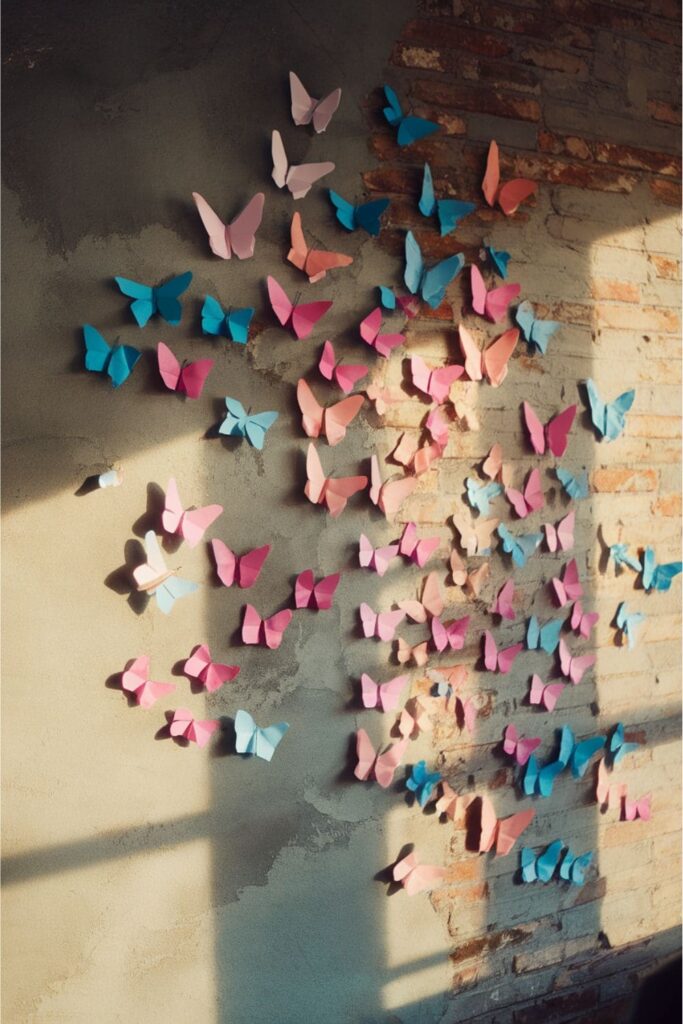 Sticky note origami butterflies on a wall with sunlight