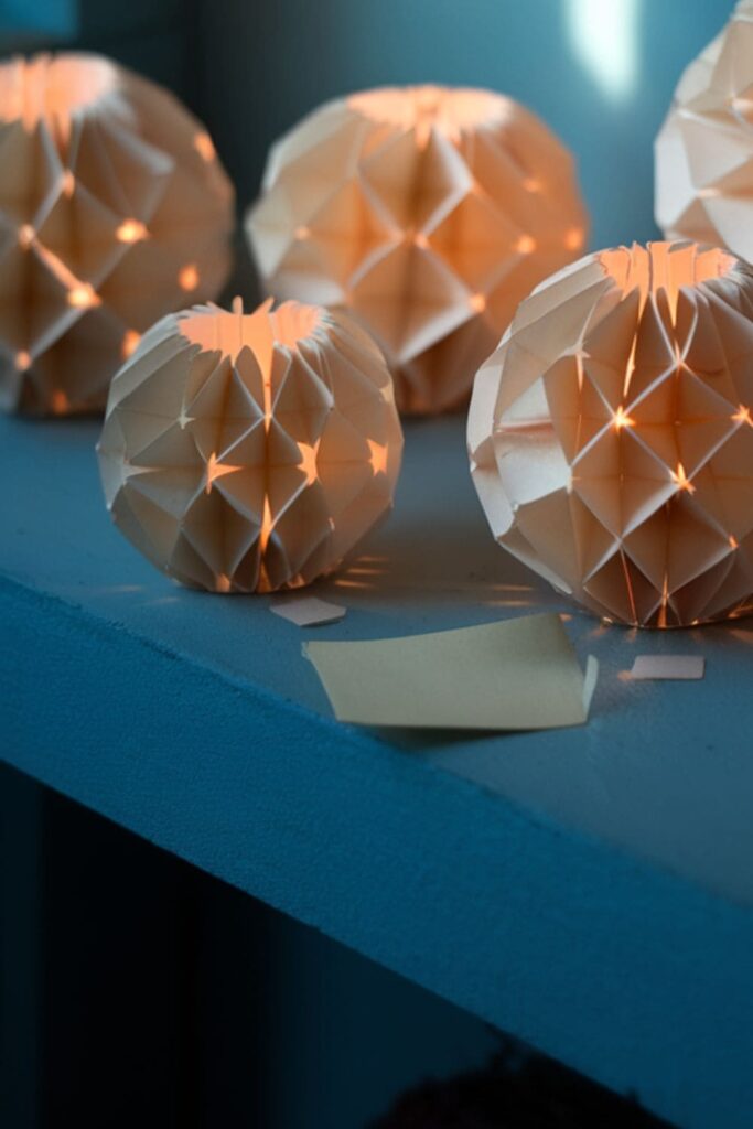 Sticky note paper lanterns glowing near a window