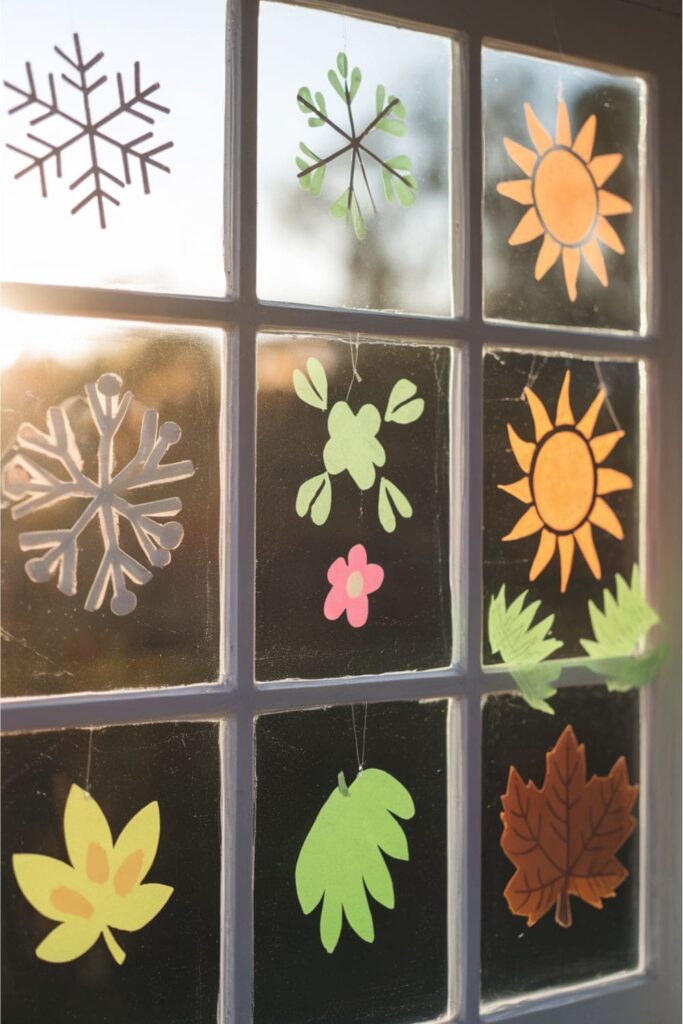 Sticky note seasonal decorations on a sunlit window