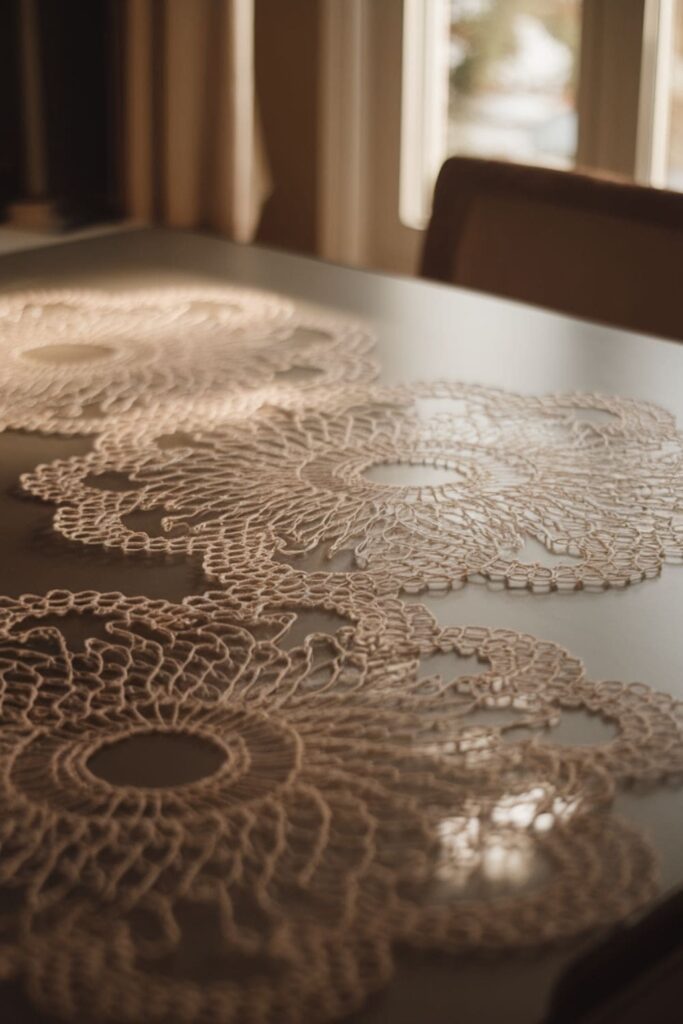 Translucent hot glue doily with intricate lace patterns on a table