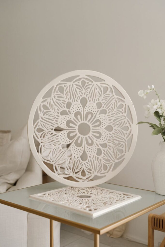 White floral-pattern air vent cover on a table in a minimalist room